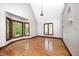 Living room with hardwood floors and large windows offering natural light and views of the outdoors at 4302 Kessler Blvd N Dr, Indianapolis, IN 46220