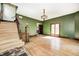 A living room showing refinished hardwood floors, fresh paint, original staircase at 4302 Kessler Blvd N Dr, Indianapolis, IN 46220