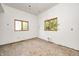 Awaiting your design ideas, an empty room features exposed studs and natural light at 4302 Kessler Blvd N Dr, Indianapolis, IN 46220
