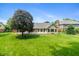 Backyard with a lush lawn and a home featuring a brick patio and enclosed sunroom at 4351 W Fox Ridge Ave, Greenwood, IN 46143
