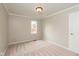 Bright bedroom with neutral carpet and trim; features a single window and white door at 4351 W Fox Ridge Ave, Greenwood, IN 46143