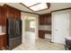 Modern kitchen with stainless steel appliances, desk area, and dark wood cabinets and trim at 4351 W Fox Ridge Ave, Greenwood, IN 46143