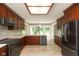 Modern kitchen with stainless steel appliances, dark wood cabinets, white countertops, and lots of natural light at 4351 W Fox Ridge Ave, Greenwood, IN 46143