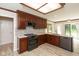 Modern kitchen featuring stainless steel appliances, light countertops, and dark wood cabinets at 4351 W Fox Ridge Ave, Greenwood, IN 46143