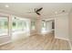 Bright and open living room with hardwood floors and multiple windows overlooking the backyard at 4351 W Fox Ridge Ave, Greenwood, IN 46143