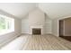 Bright living room with a fireplace, built-in shelving, large windows, and neutral flooring at 4351 W Fox Ridge Ave, Greenwood, IN 46143