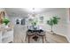 Open floor plan, modern chandelier over round dining table, with access to kitchen at 444 Buffalo Dr, Indianapolis, IN 46217