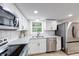 Bright kitchen featuring stainless appliances, sleek countertops, white cabinetry, and modern fixtures at 444 Buffalo Dr, Indianapolis, IN 46217