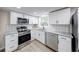 Modern kitchen features new stainless steel appliances, granite countertops, and white cabinets at 444 Buffalo Dr, Indianapolis, IN 46217