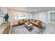 Bright living room featuring modern furniture, neutral walls, decorative rug, recessed lighting, and large front window at 444 Buffalo Dr, Indianapolis, IN 46217