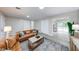 Cozy living room with updated flooring, comfortable sofas, and a view of the outdoor deck and backyard at 444 Buffalo Dr, Indianapolis, IN 46217