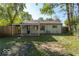 Home featuring large backyard with lush trees and covered patio at 4716 E 33Rd St, Indianapolis, IN 46218