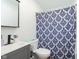 Bathroom featuring a vanity, toilet, and shower with blue patterned curtain at 4716 E 33Rd St, Indianapolis, IN 46218