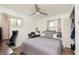 Comfortable bedroom features wood-look floors, two windows and a ceiling fan at 4716 E 33Rd St, Indianapolis, IN 46218