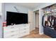 Bright bedroom with wood-look flooring, closet and storage drawers at 4716 E 33Rd St, Indianapolis, IN 46218