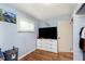 Bright bedroom featuring wood-look floors, a window, and a large dresser at 4716 E 33Rd St, Indianapolis, IN 46218