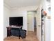 Bedroom featuring an open door to a bathroom, TV, and wood-look floors at 4716 E 33Rd St, Indianapolis, IN 46218