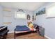Bedroom with wood-look floors, window, shelving and single bed at 4716 E 33Rd St, Indianapolis, IN 46218