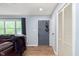 Inviting entryway featuring wood flooring, a closet, and a view into the living area with a leather sofa at 4716 E 33Rd St, Indianapolis, IN 46218