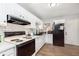 Bright kitchen featuring white cabinetry, subway tile backsplash, and updated appliances on wood-look floors at 4716 E 33Rd St, Indianapolis, IN 46218