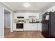 Updated kitchen with white cabinets, black appliances, tile backsplash and wood-look flooring at 4716 E 33Rd St, Indianapolis, IN 46218