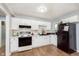 Updated kitchen with white cabinets, a black refrigerator, and modern fixtures at 4716 E 33Rd St, Indianapolis, IN 46218