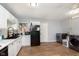 Functional kitchen with white cabinets, black appliances, and a washer and dryer for added convenience at 4716 E 33Rd St, Indianapolis, IN 46218