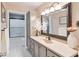 Bathroom vanity and sink area, with storage cabinet and decorative mirror at 4732 Ferguson Rd, Indianapolis, IN 46239