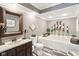 Relaxing bathroom features a soaking tub, wood-look floors, and dark wood vanity at 4732 Ferguson Rd, Indianapolis, IN 46239