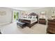 Spacious bedroom with detailed wood furniture and a walkout to the yard at 4732 Ferguson Rd, Indianapolis, IN 46239