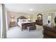 Large bedroom featuring detailed wood furniture, plush carpet, and lots of space at 4732 Ferguson Rd, Indianapolis, IN 46239