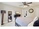 Bedroom features neutral walls, plush carpet, tv, and ceiling fan at 4732 Ferguson Rd, Indianapolis, IN 46239