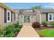 Home featuring a stone entrance way, double entry doors, and professional landscaping along the concrete walkway at 4732 Ferguson Rd, Indianapolis, IN 46239