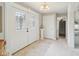 Bright foyer featuring decorative glass doors, light tile, and white trim at 4732 Ferguson Rd, Indianapolis, IN 46239