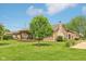 Charming home featuring a stone chimney and inviting back deck, perfect for outdoor living at 4732 Ferguson Rd, Indianapolis, IN 46239