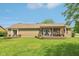 Rear exterior featuring a deck, a well manicured lawn and a view of the surrounding yard at 4732 Ferguson Rd, Indianapolis, IN 46239