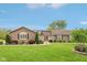 Charming ranch home featuring professional landscaping, covered entry, stone accents and a sprawling front lawn at 4732 Ferguson Rd, Indianapolis, IN 46239