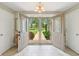 Well-lit foyer boasting ceramic tile floors, double doors, neutral walls, and an exterior view at 4732 Ferguson Rd, Indianapolis, IN 46239
