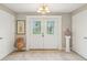 Spacious front foyer with double doors, decorative lighting, ceramic tile flooring, and neutral paint at 4732 Ferguson Rd, Indianapolis, IN 46239