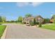 A detached two car garage featuring professional landscaping, concrete walkway, and vinyl siding at 4732 Ferguson Rd, Indianapolis, IN 46239