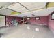 Large garage with painted floor, red accent wall and ample storage at 4732 Ferguson Rd, Indianapolis, IN 46239