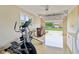 Finished garage with epoxied floors, a window, and exercise equipment at 4732 Ferguson Rd, Indianapolis, IN 46239