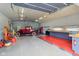 Well-lit garage featuring a vintage car, ample workspace, and organized storage solutions at 4732 Ferguson Rd, Indianapolis, IN 46239