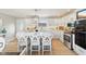 Bright kitchen features center island with seating, stainless appliances, and white cabinetry at 4732 Ferguson Rd, Indianapolis, IN 46239