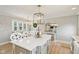 Spacious eat-in kitchen with center island, modern lighting, and bright white cabinets at 4732 Ferguson Rd, Indianapolis, IN 46239