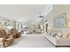 Spacious living room with vaulted ceiling, neutral colors, fireplace, plush carpet and many windows at 4732 Ferguson Rd, Indianapolis, IN 46239