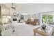 A spacious living room with vaulted ceilings, fireplace, recessed lighting, plush carpet, and lots of natural light at 4732 Ferguson Rd, Indianapolis, IN 46239