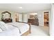 Main bedroom features a large dresser, mounted tv, and ensuite bathroom at 4732 Ferguson Rd, Indianapolis, IN 46239