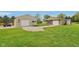 A view of two outbuildings and a shed on a property with green grass and blue skies at 4732 Ferguson Rd, Indianapolis, IN 46239