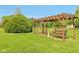 Tranquil backyard pergola with a charming swing and mature landscaping, creating a serene outdoor retreat at 4732 Ferguson Rd, Indianapolis, IN 46239